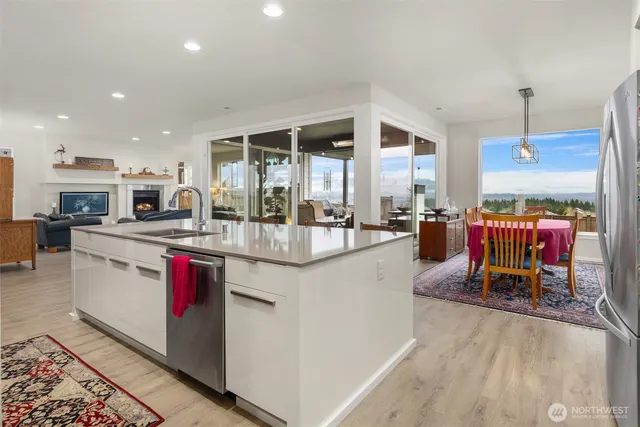 a kitchen with stainless steel appliances kitchen island granite countertop a sink and cabinets