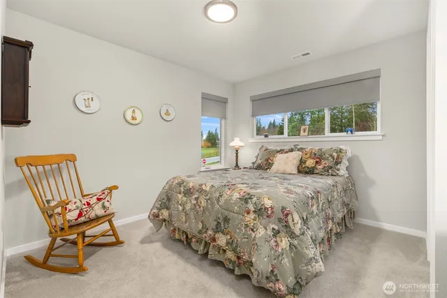 a bed sitting in a bedroom next to a window