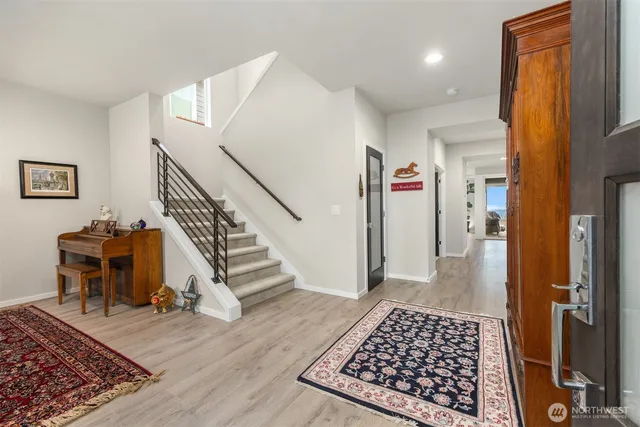 a view of entryway with furniture and wooden floor