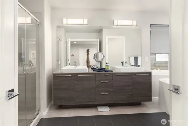a bathroom with a vanity a sink a mirror a vanity and shower