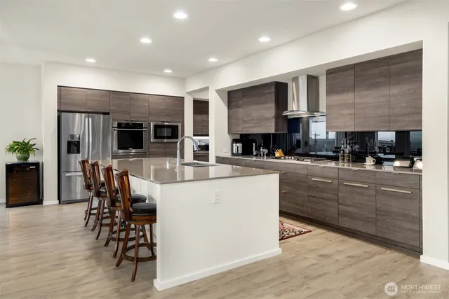 a kitchen with stainless steel appliances granite countertop a stove and a refrigerator