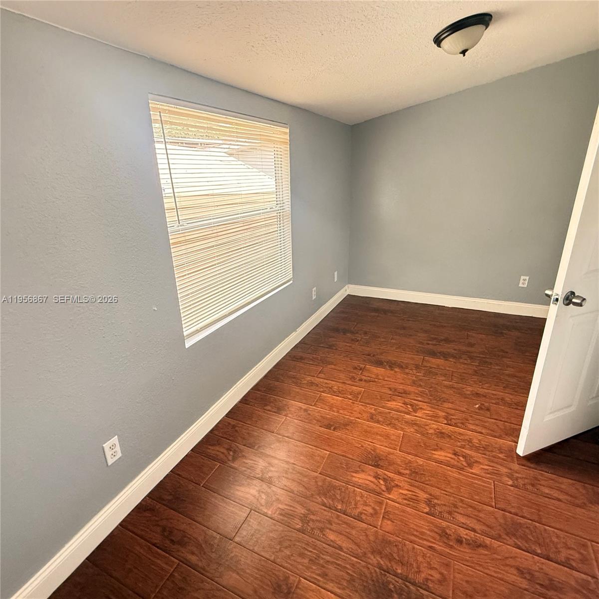770 Broone Clermont, FL 34711 - Photo 15 of 32 an empty room with wooden floor and windows