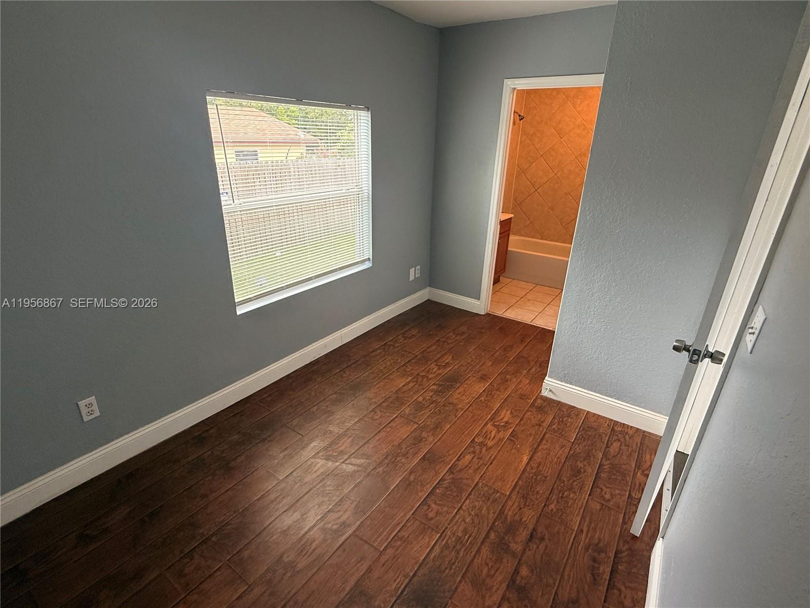 770 Broone Clermont, FL 34711 - Photo 18 of 32 an empty room with wooden floor and windows