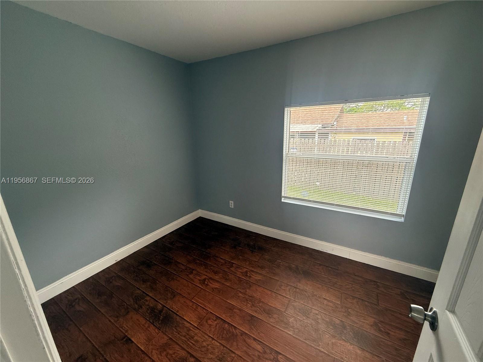 770 Broone Clermont, FL 34711 - Photo 20 of 32 a view of an empty room with wooden floor and a window