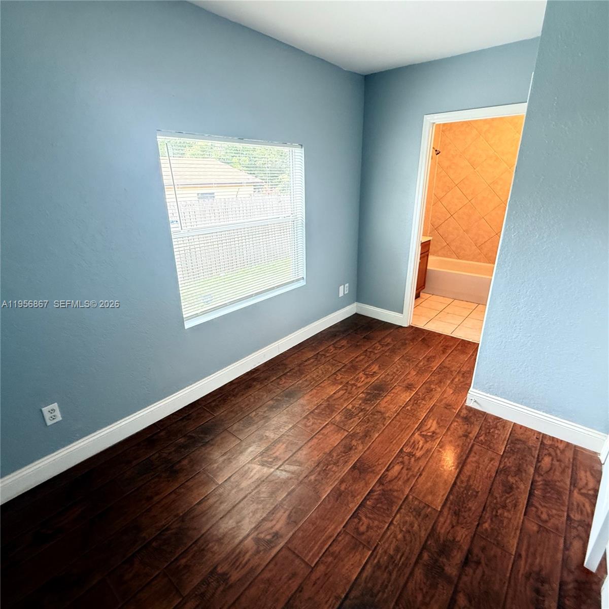 770 Broone Clermont, FL 34711 - Photo 21 of 32 an empty room with wooden floor and windows