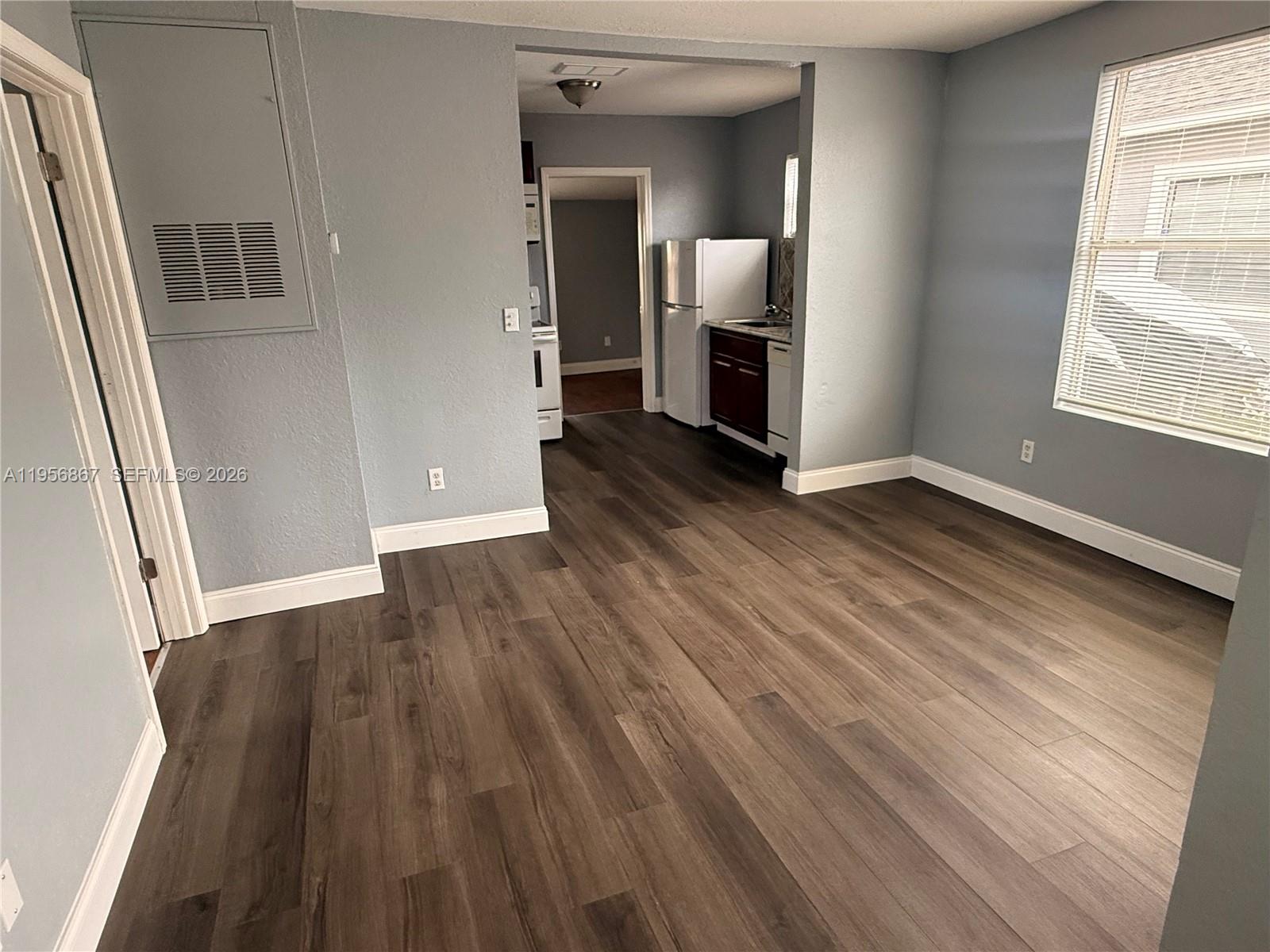 770 Broone Clermont, FL 34711 - Photo 4 of 32 wooden floor in an empty room with a window