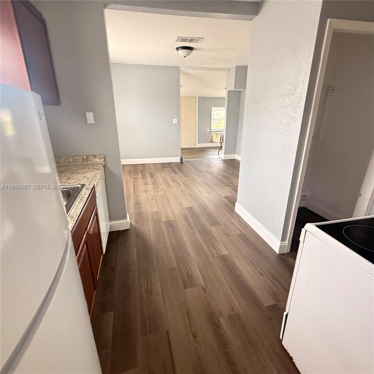 770 Broone Clermont, FL 34711 - Photo 5 of 32 wooden floor in an empty room with a window