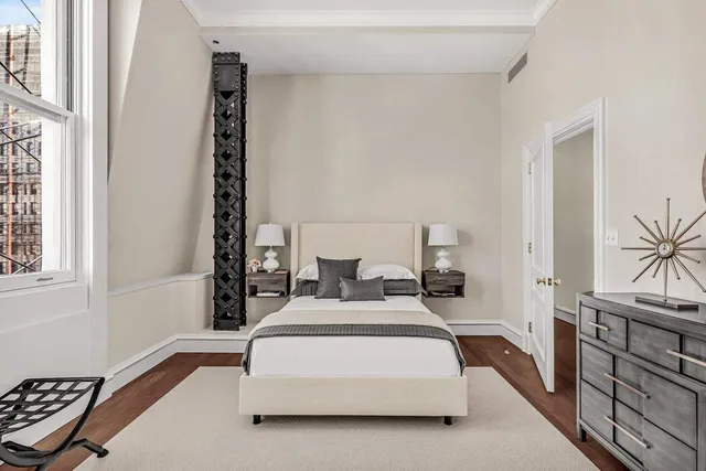 a bedroom with double bed and a window