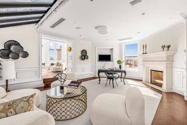 a living room with furniture and fireplace