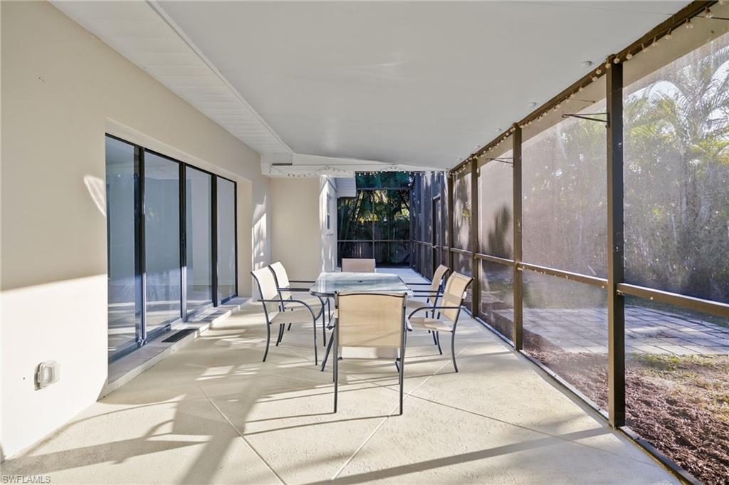 3581 Corana Way Naples, FL 34105 - Photo 19 of 26 a dining room with furniture and a rug