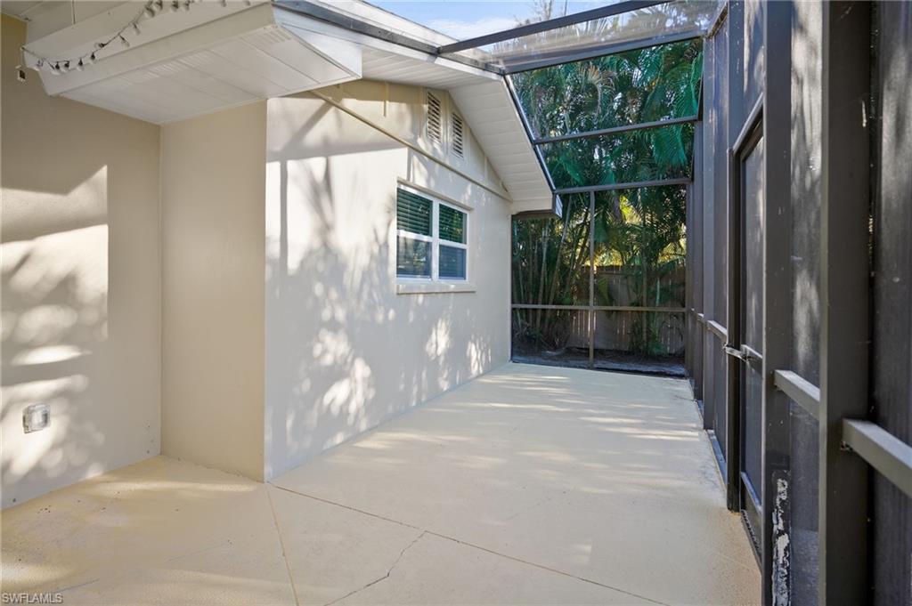 3581 Corana Way Naples, FL 34105 - Photo 20 of 26 a view of outdoor space with sliding door and windows