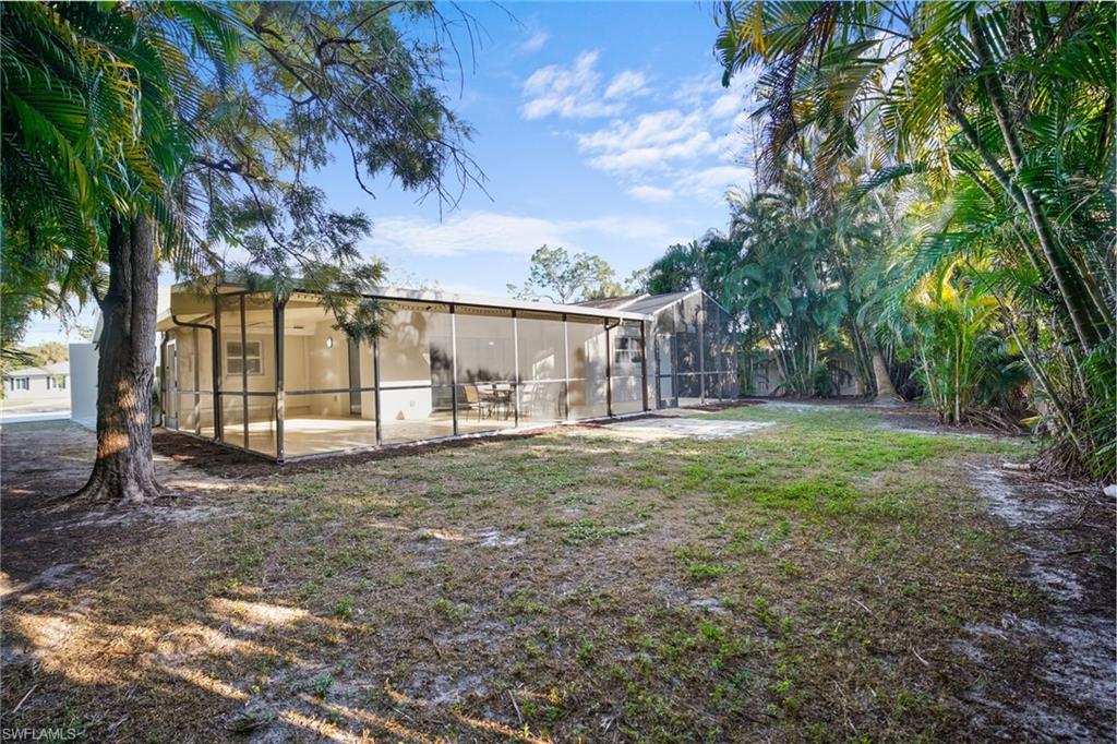 3581 Corana Way Naples, FL 34105 - Photo 22 of 26 a view of a house with backyard and a tree
