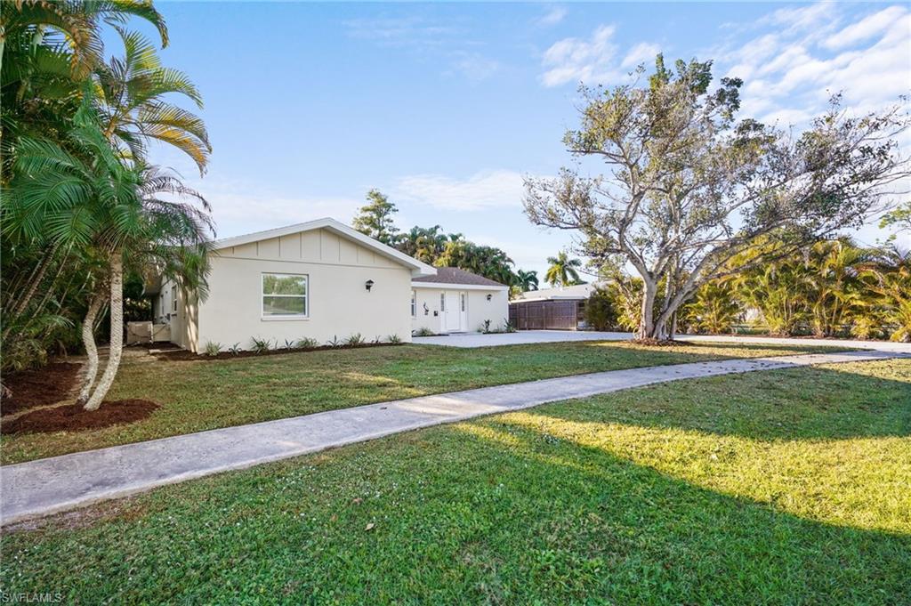 3581 Corana Way Naples, FL 34105 - Photo 23 of 26 a view of a house with a yard