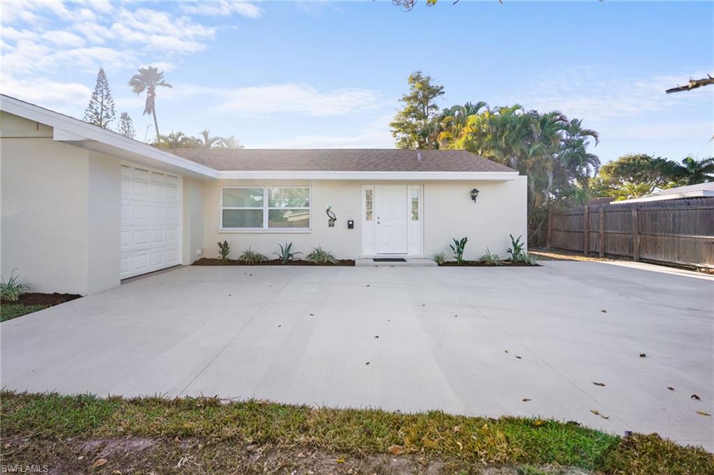 3581 Corana Way Naples, FL 34105 - Photo 26 of 26 a view of a white house with a dry yard