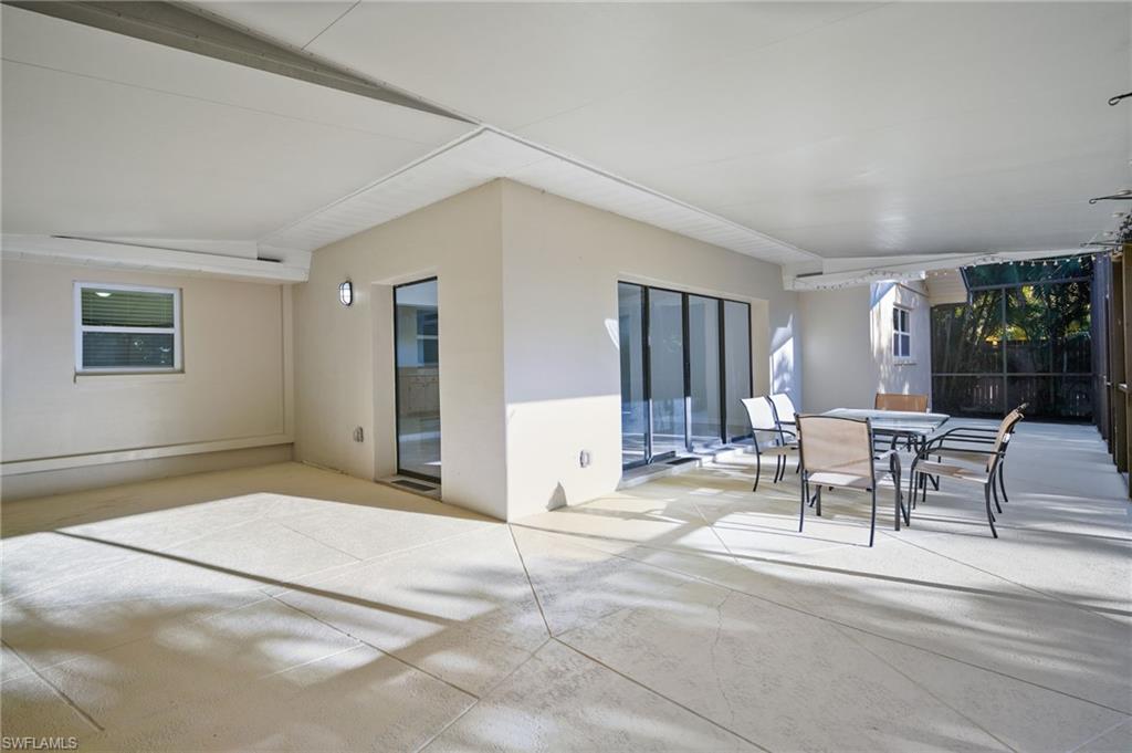 3581 Corana Way Naples, FL 34105 - Photo 4 of 26 a view of a livingroom with furniture and floor to ceiling window