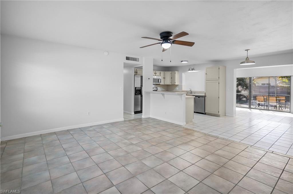 3581 Corana Way Naples, FL 34105 - Photo 6 of 26 a view of a kitchen with a sink and a refrigerator