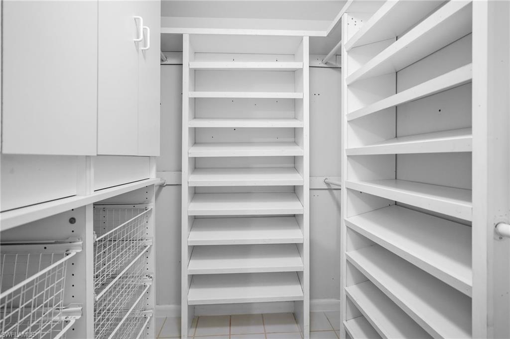 3581 Corana Way Naples, FL 34105 - Photo 8 of 26 a view of walk in closet with empty racks
