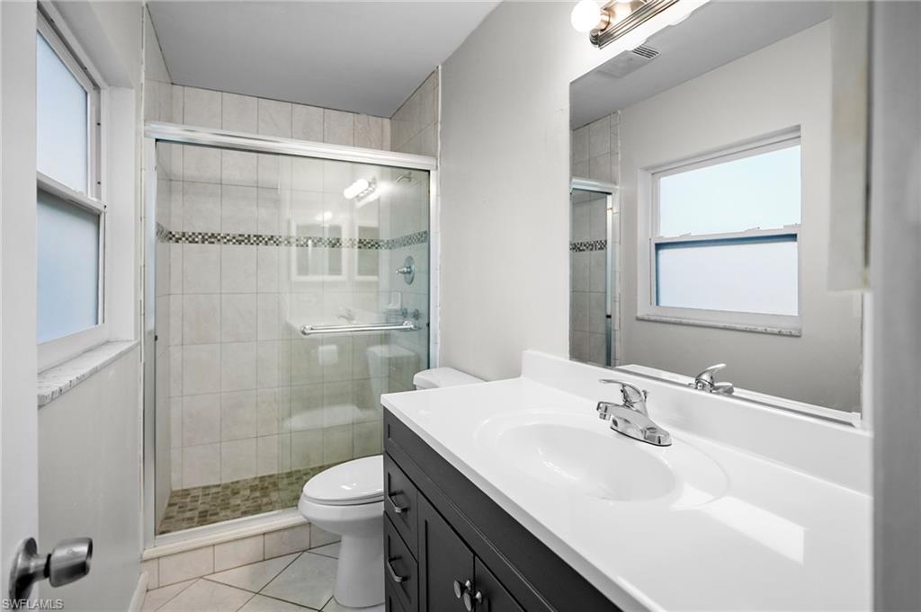 3581 Corana Way Naples, FL 34105 - Photo 10 of 26 a bathroom with a sink a toilet and shower