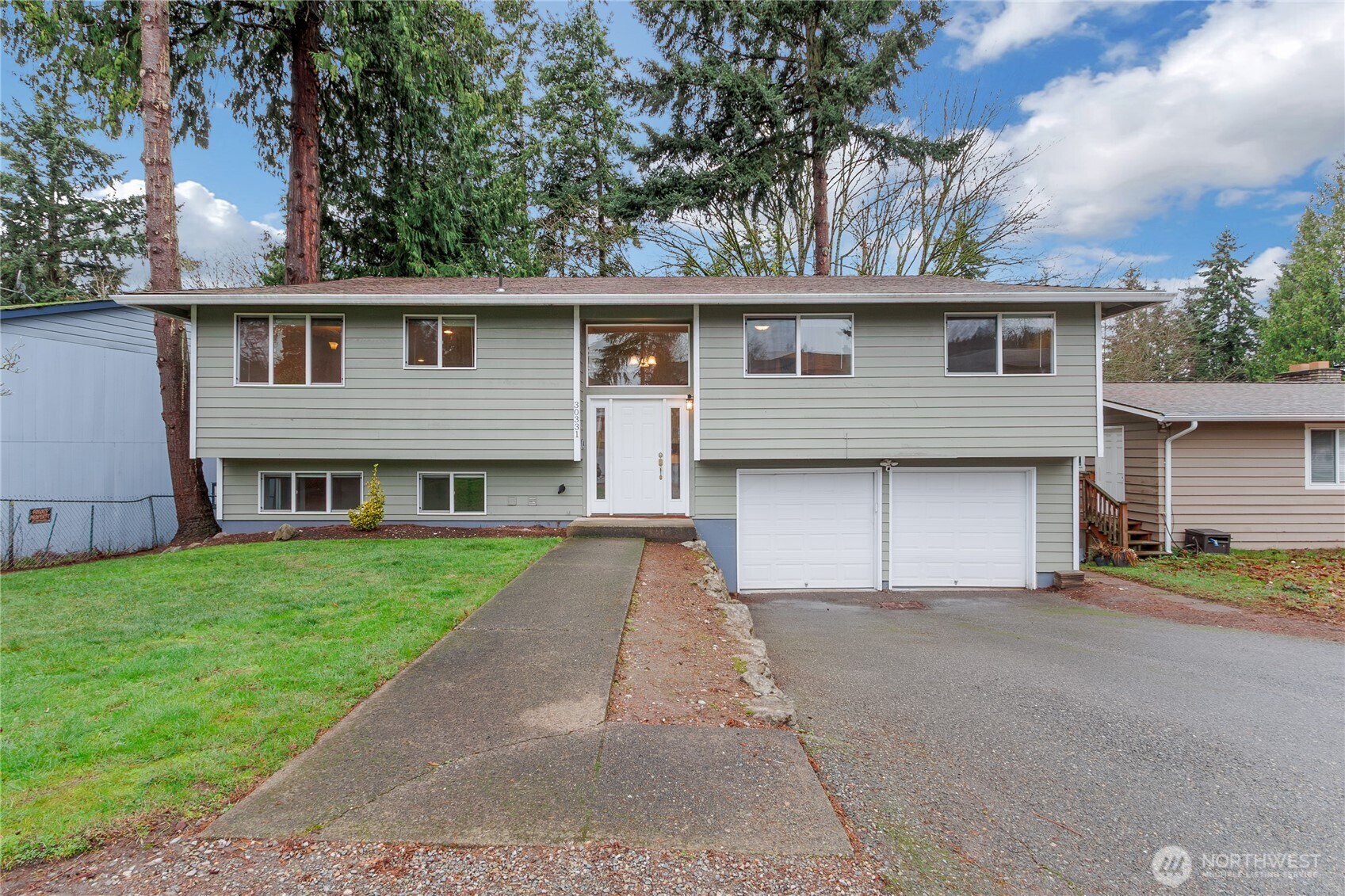 30331 9th Avenue South Federal Way, WA 98003 - Photo 1 of 36 a front view of a house with a garden and trees