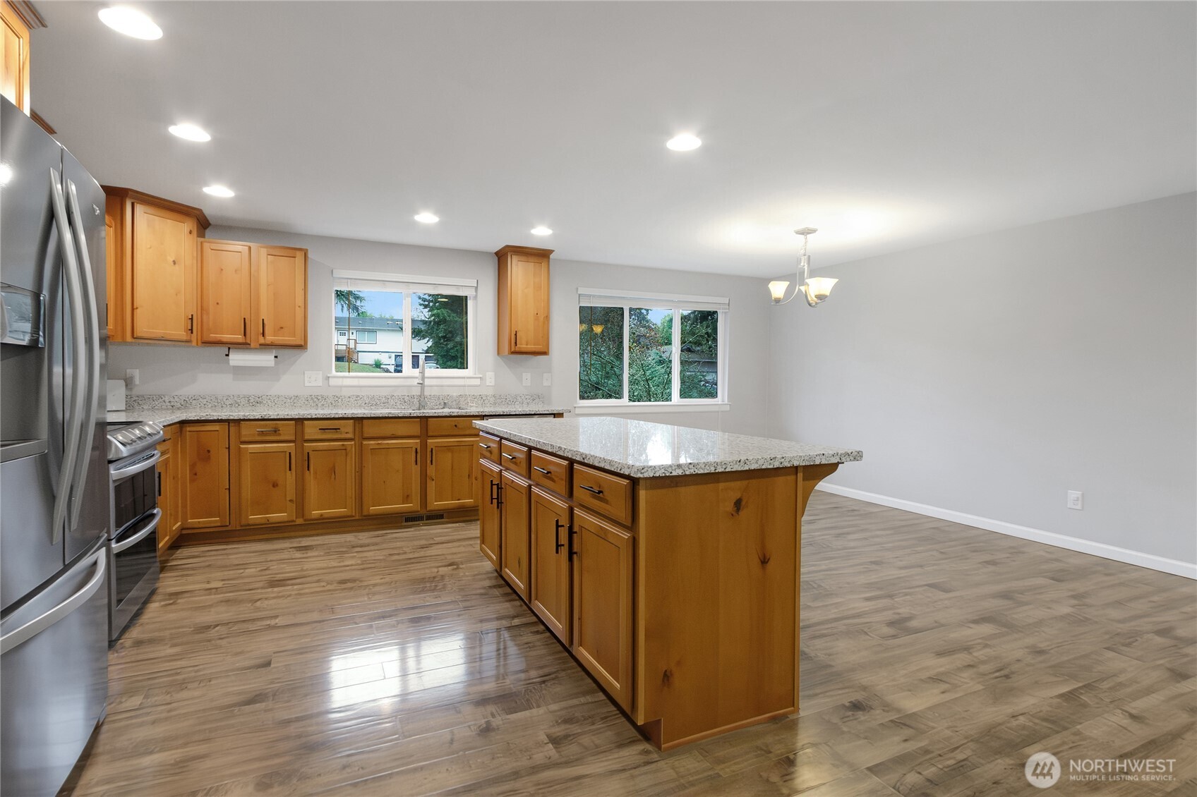 30331 9th Avenue South Federal Way, WA 98003 - Photo 11 of 36 a kitchen with stainless steel appliances granite countertop a sink a stove a refrigerator cabinets and a kitchen island