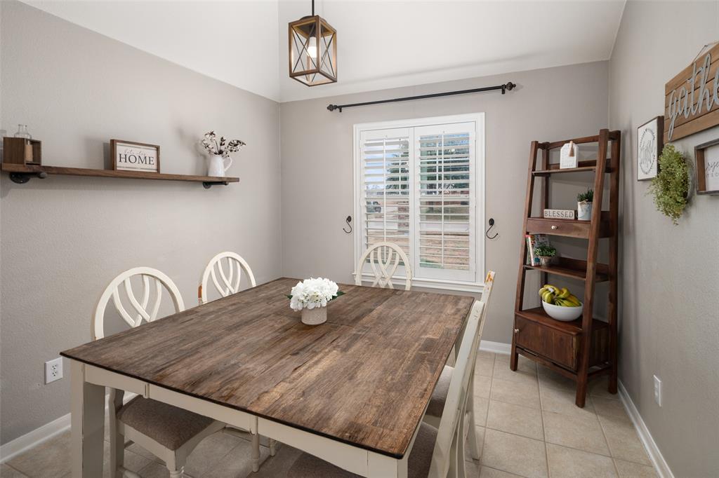 7604 Uvalde Way McKinney, TX 75071 - Photo 8 of 34 Dining Area featuring plantation shutters, decorative lighting and view to the front yard.