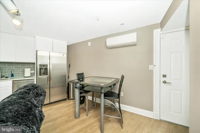 a kitchen with stainless steel appliances a stove microwave and refrigerator