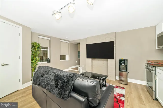 a living room with furniture and kitchen view