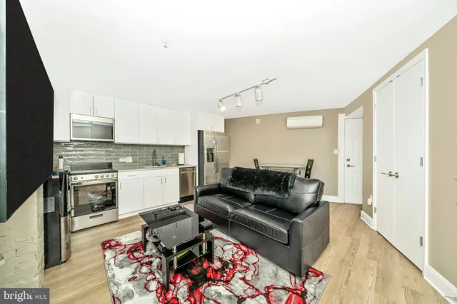 a kitchen with stainless steel appliances a stove microwave and refrigerator