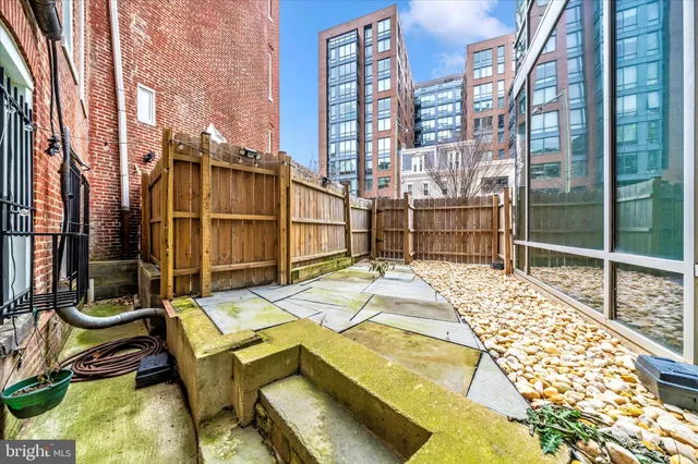 a view of a balcony with a floor to ceiling window next to a building