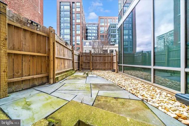 a backyard of a house with table and chairs