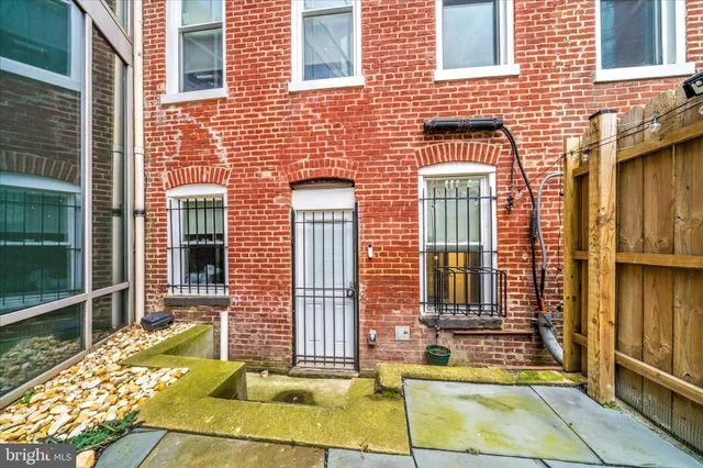 a view of a brick building next to a yard