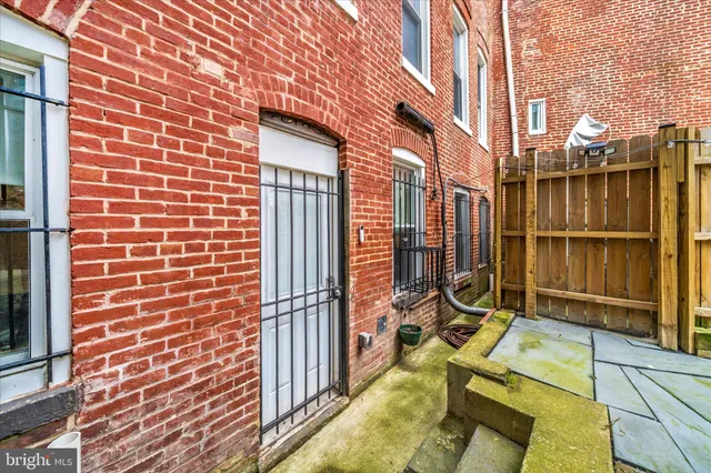 a view of a brick building next to a yard