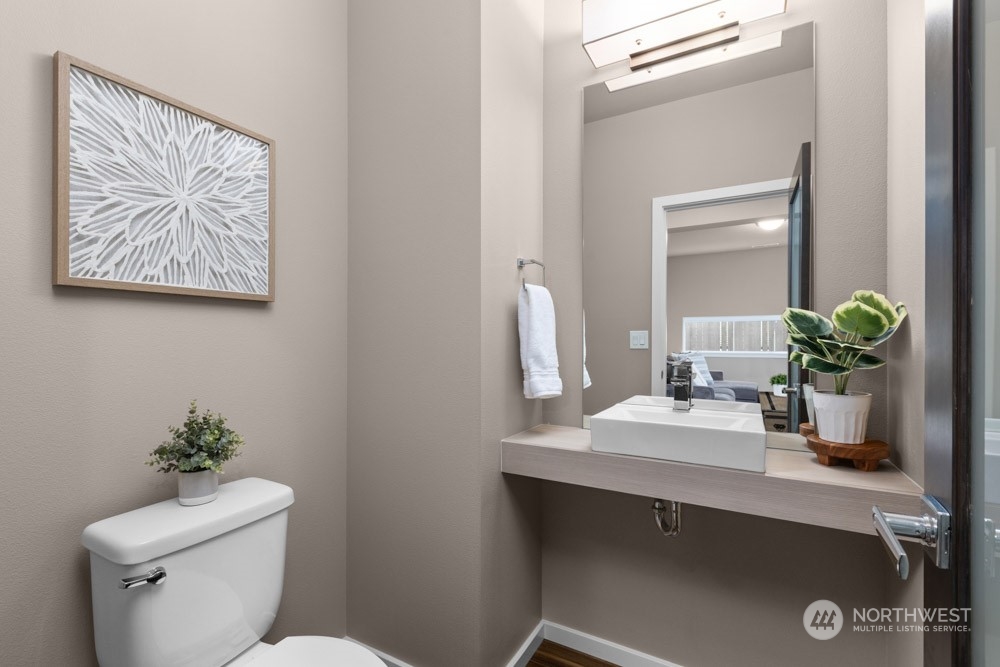4021 168th Place Southeast Bothell, WA 98012 - Photo 16 of 39 a bathroom with a toilet a sink and mirror