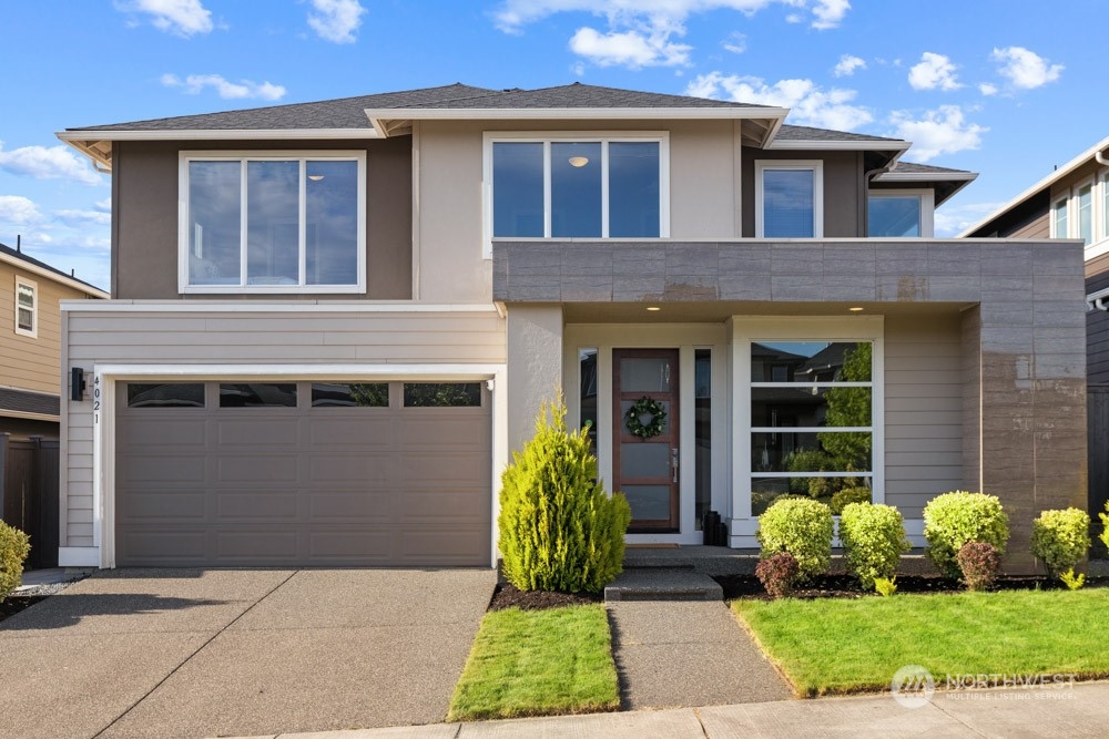 4021 168th Place Southeast Bothell, WA 98012 - Photo 2 of 39 a front view of brick house with a garden