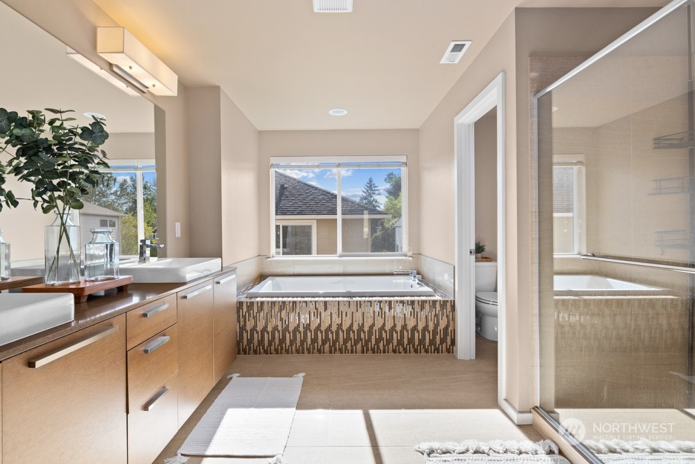 4021 168th Place Southeast Bothell, WA 98012 - Photo 22 of 39 a en suite bathroom with a bathtub and sink