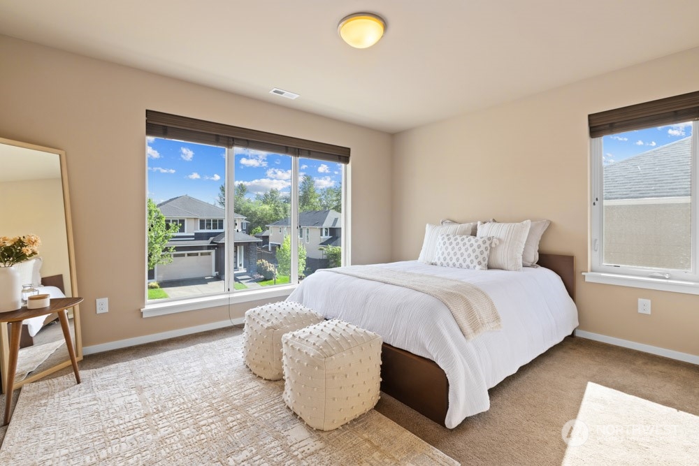 4021 168th Place Southeast Bothell, WA 98012 - Photo 26 of 39 a spacious bedroom with a large bed and a large window