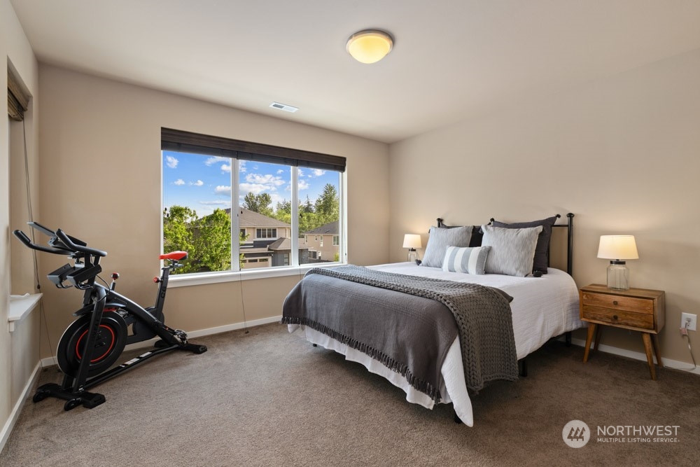 4021 168th Place Southeast Bothell, WA 98012 - Photo 30 of 39 a bed room with a bed and a chair