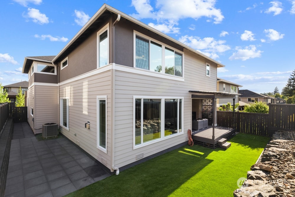 4021 168th Place Southeast Bothell, WA 98012 - Photo 36 of 39 a view of a white house with a yard and furniture
