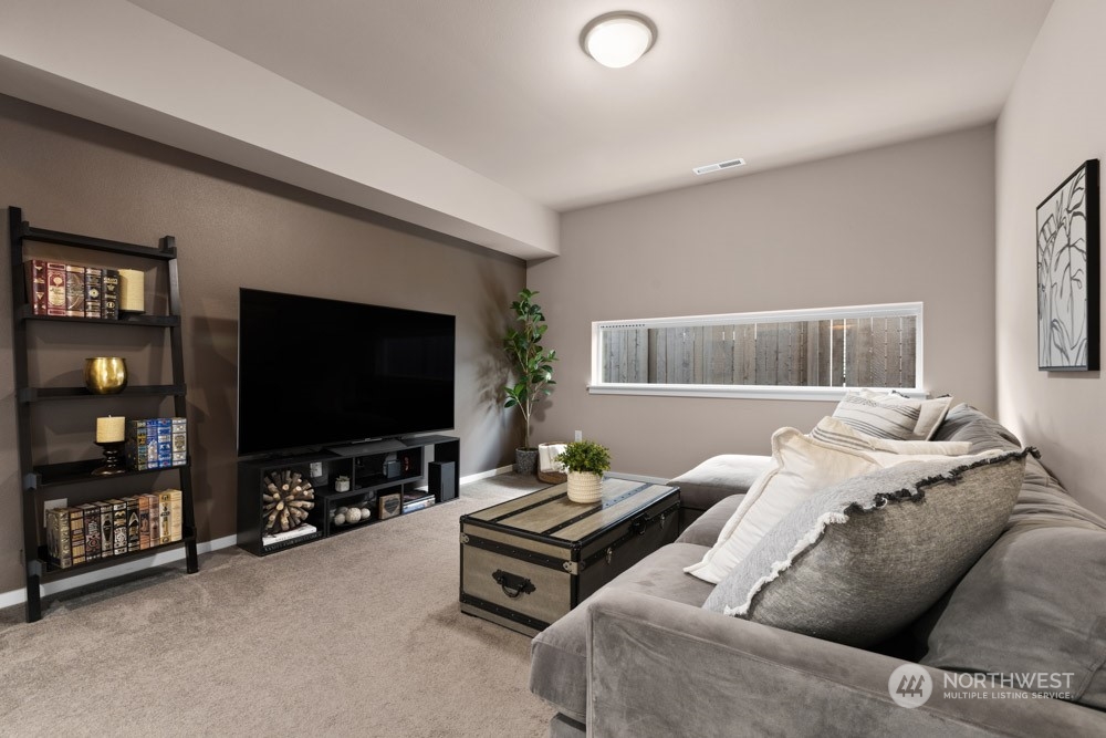 4021 168th Place Southeast Bothell, WA 98012 - Photo 7 of 39 a living room with furniture and a flat screen tv