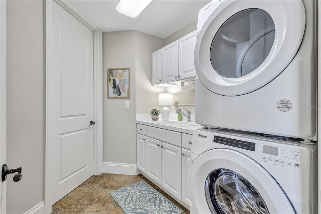 140 Riviera Dunes Way, Unit 206 Palmetto, FL 34221 - Photo 12 of 46 a view of a storage and utility room with washer and dryer