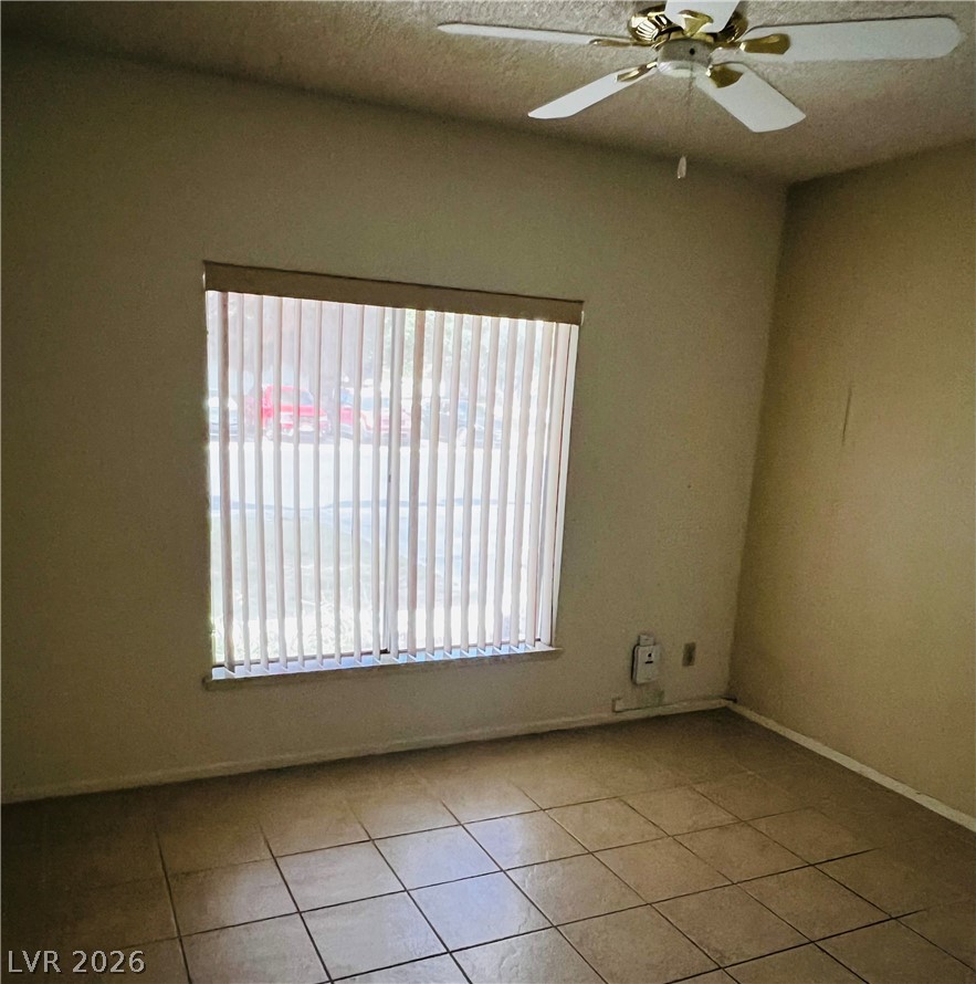 709 Ridgemount Drive Las Vegas, NV 89107 - Photo 15 of 40 Bedroom #3 with ceiling fan, ceramic tile.