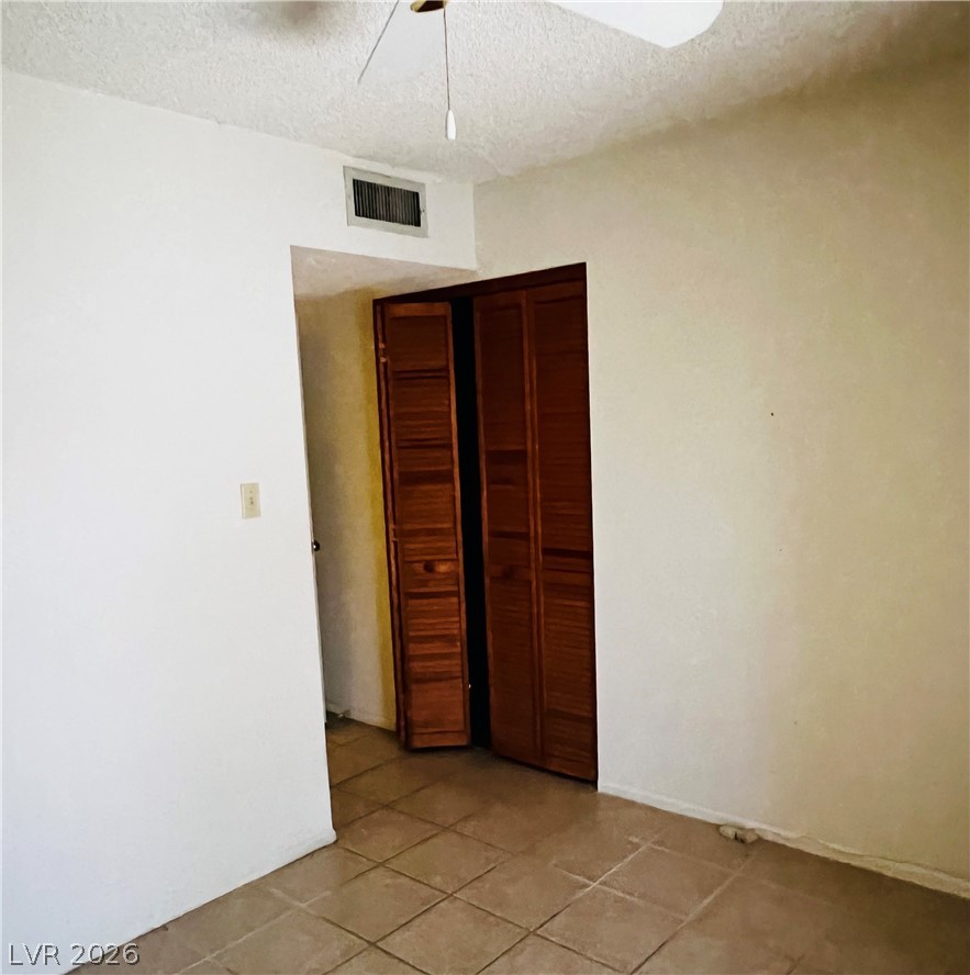 709 Ridgemount Drive Las Vegas, NV 89107 - Photo 16 of 40 Bedroom #3 with ceramic tile flooring, ceiling fan.