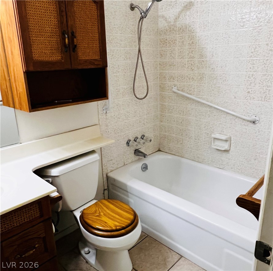 709 Ridgemount Drive Las Vegas, NV 89107 - Photo 17 of 40 Full bathroom featuring vanity, shower combination, and light tile patterned floors