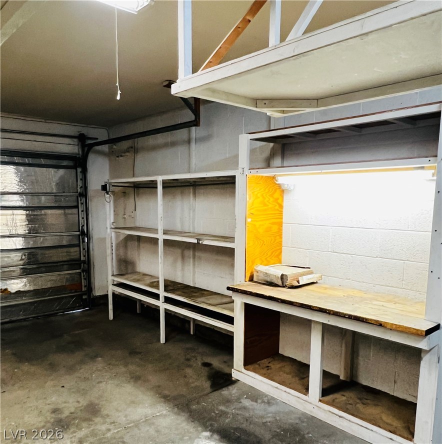 709 Ridgemount Drive Las Vegas, NV 89107 - Photo 19 of 40 Garage with concrete block wall, work bench and plenty of storage.