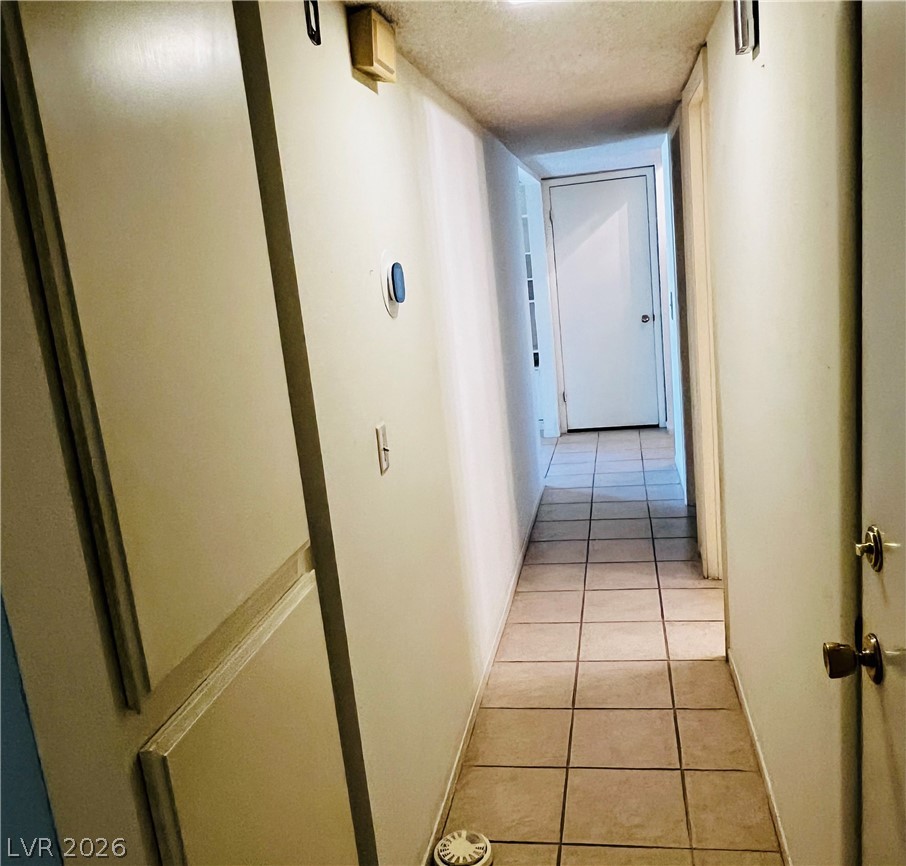 709 Ridgemount Drive Las Vegas, NV 89107 - Photo 21 of 40 Hall with light tile patterned floors.