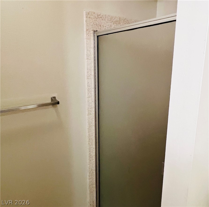 709 Ridgemount Drive Las Vegas, NV 89107 - Photo 25 of 40 Primary bath has toilet and shower separate from sink and makeup area.