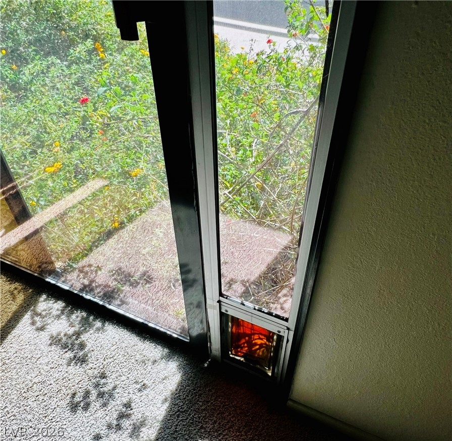 709 Ridgemount Drive Las Vegas, NV 89107 - Photo 27 of 40 Primary bedroom has patio door to patio/courtyard area. Pet door can be used or easily removed.
