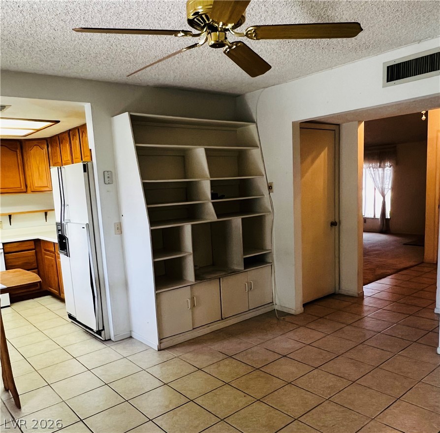 709 Ridgemount Drive Las Vegas, NV 89107 - Photo 9 of 40 Family room with ceiling fan, a textured ceiling, and light, ceramic floors