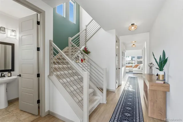 a view of a hallway with wooden floor and staircase