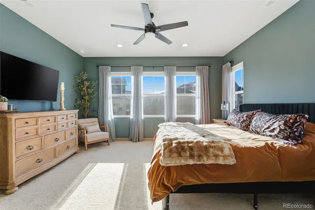 a bedroom with bed and flat tv with wooden floor